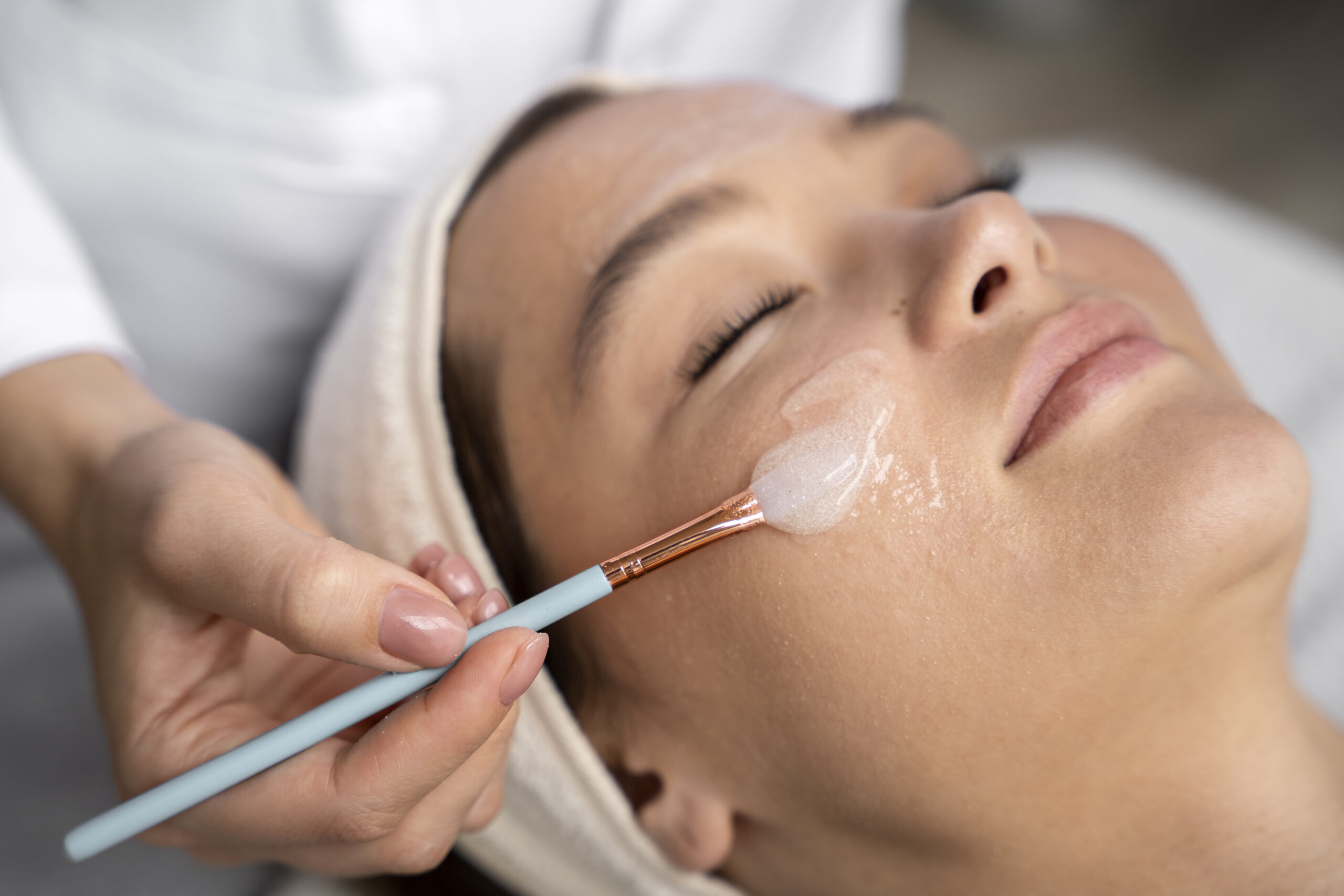 Woman with eyes closed about to receive injection