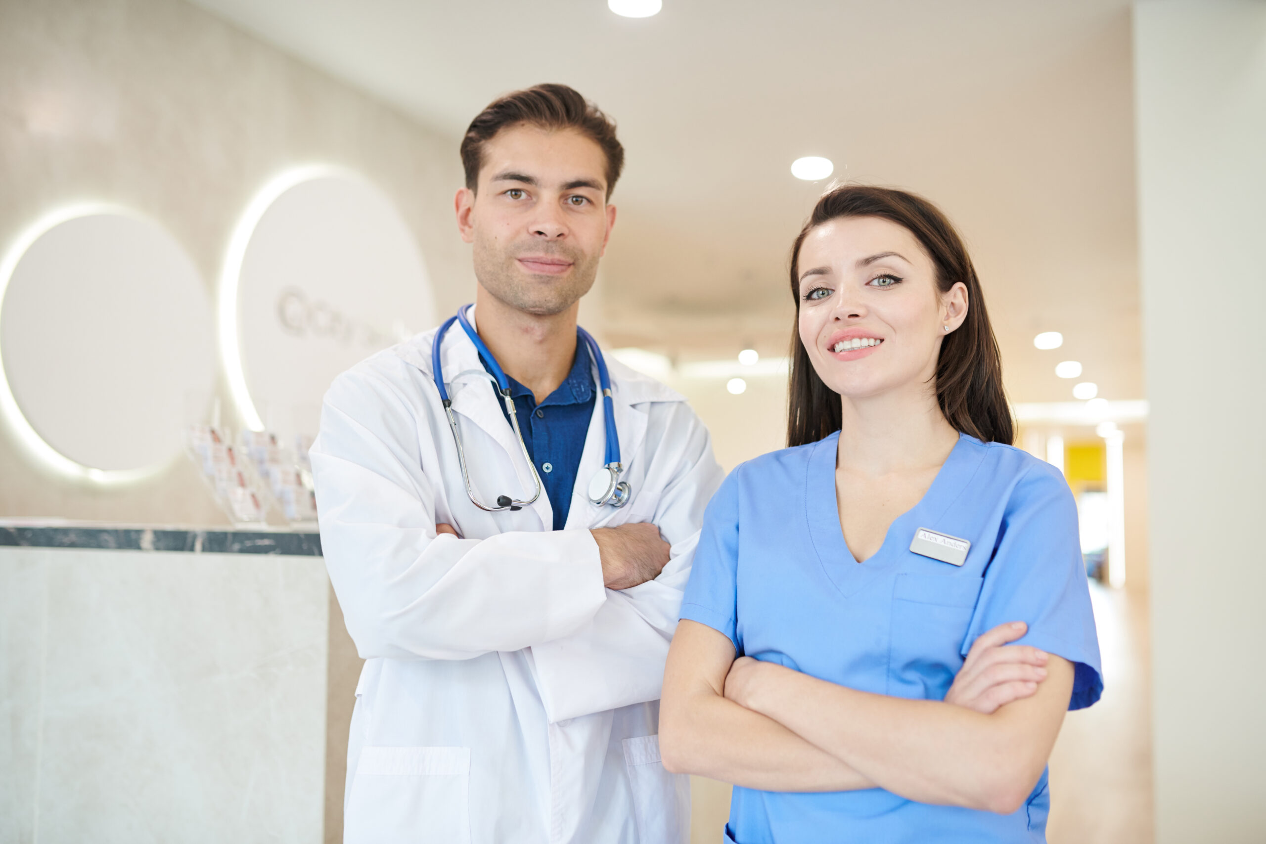Group of aesthetic medical professionals posing confidently in a modern clinical setting.