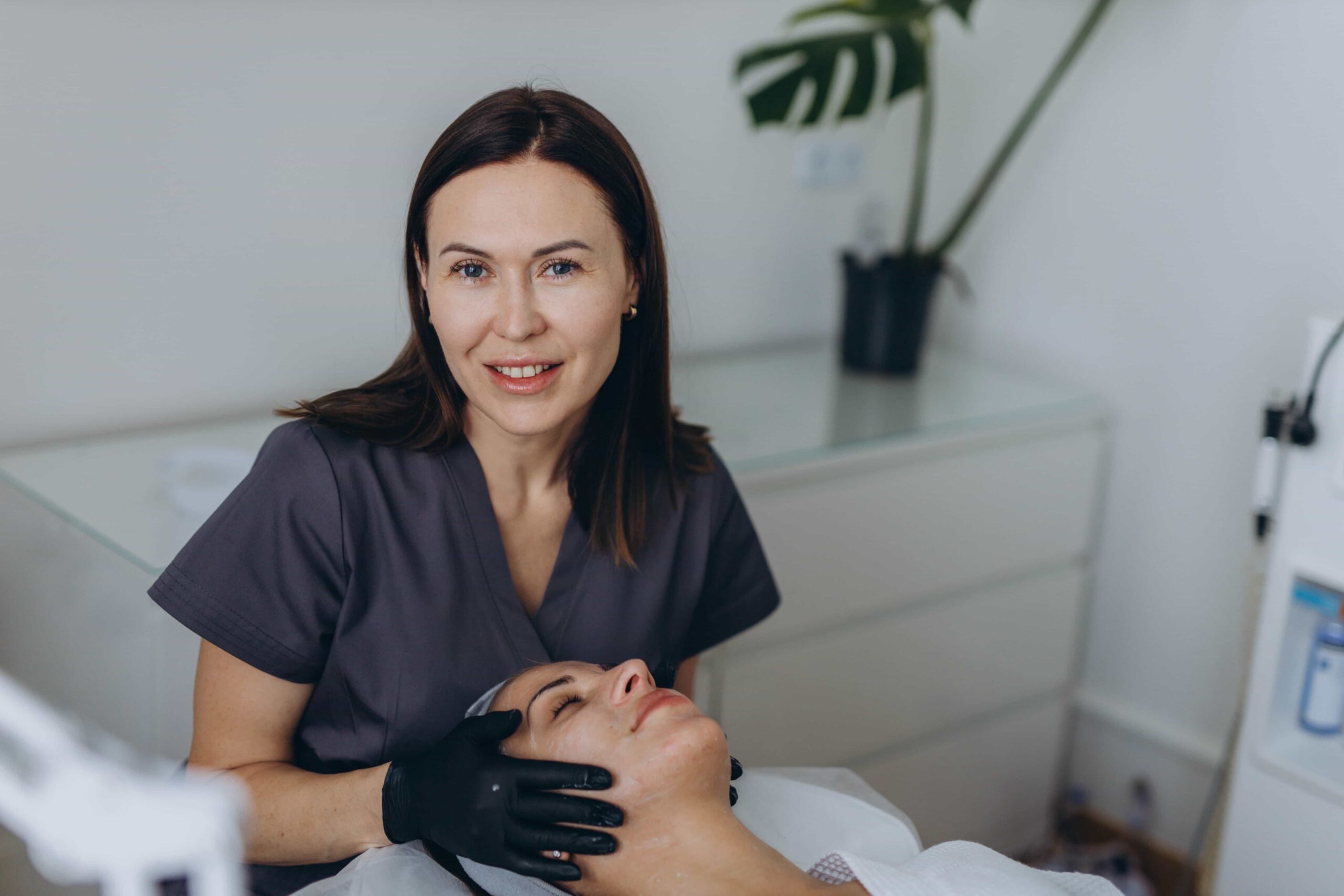 Group of aesthetic medical professionals posing confidently in a modern clinical setting.