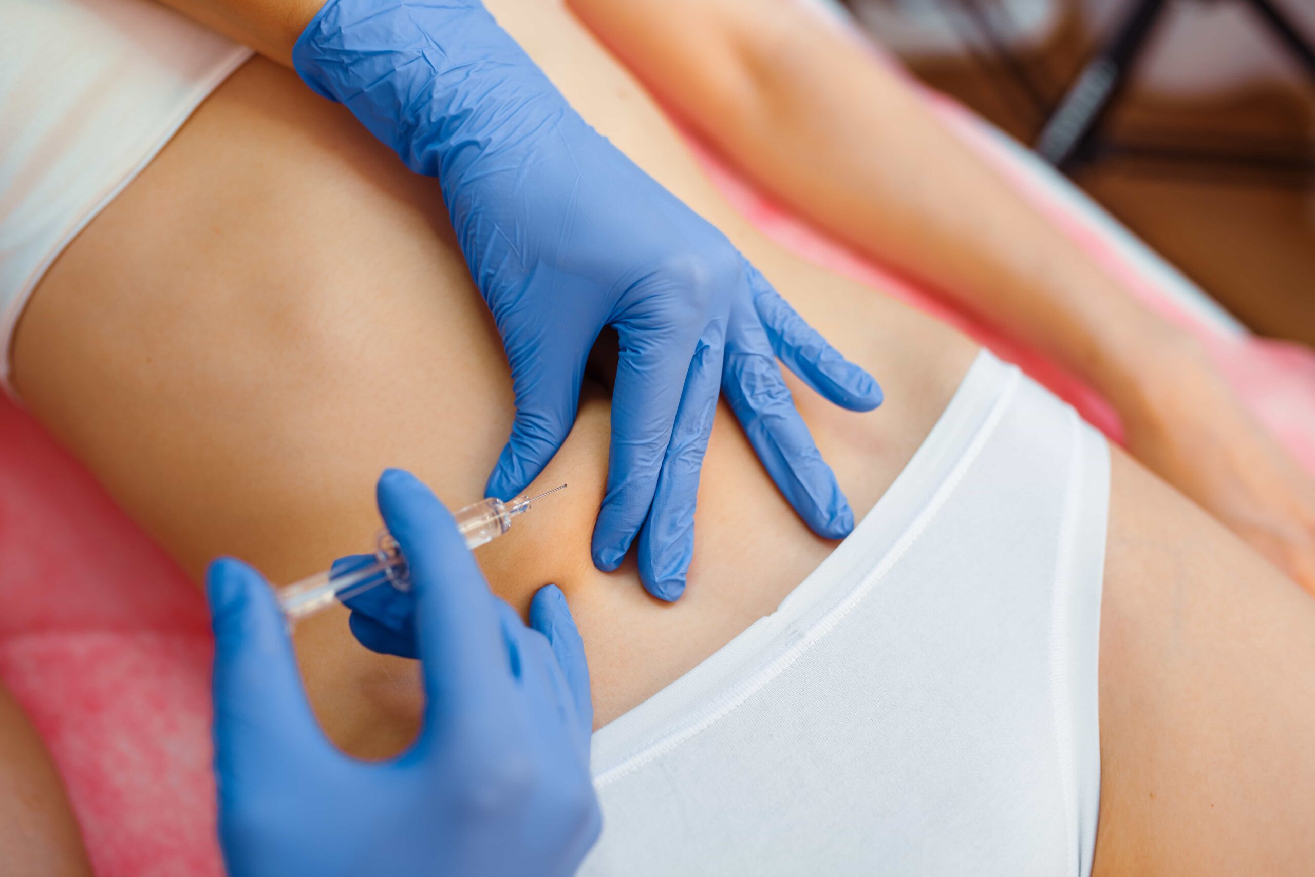 cosmetician gives injection in the stomach