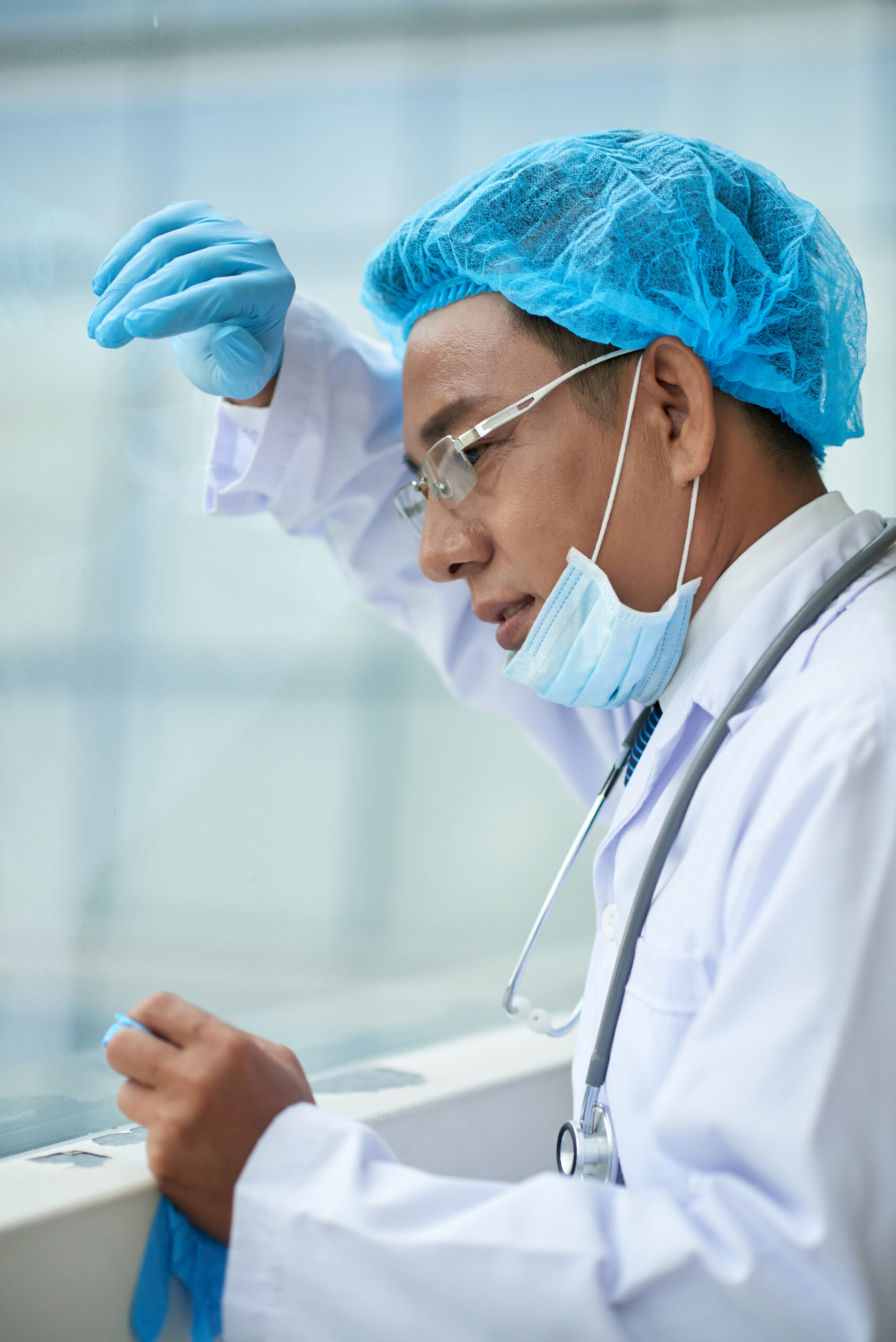 Doctor leaning against the window