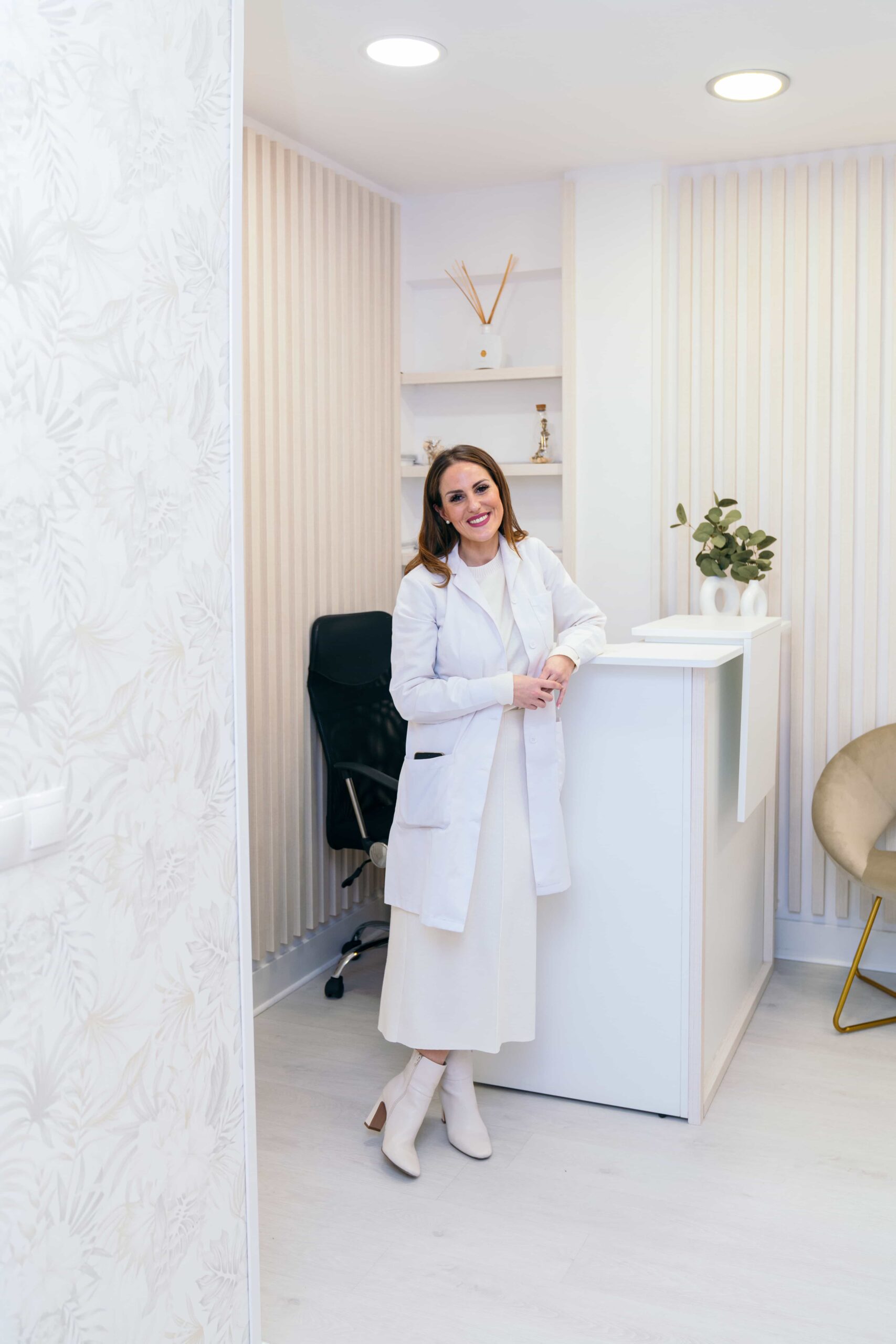 smiling professional woman in white at aesthetic