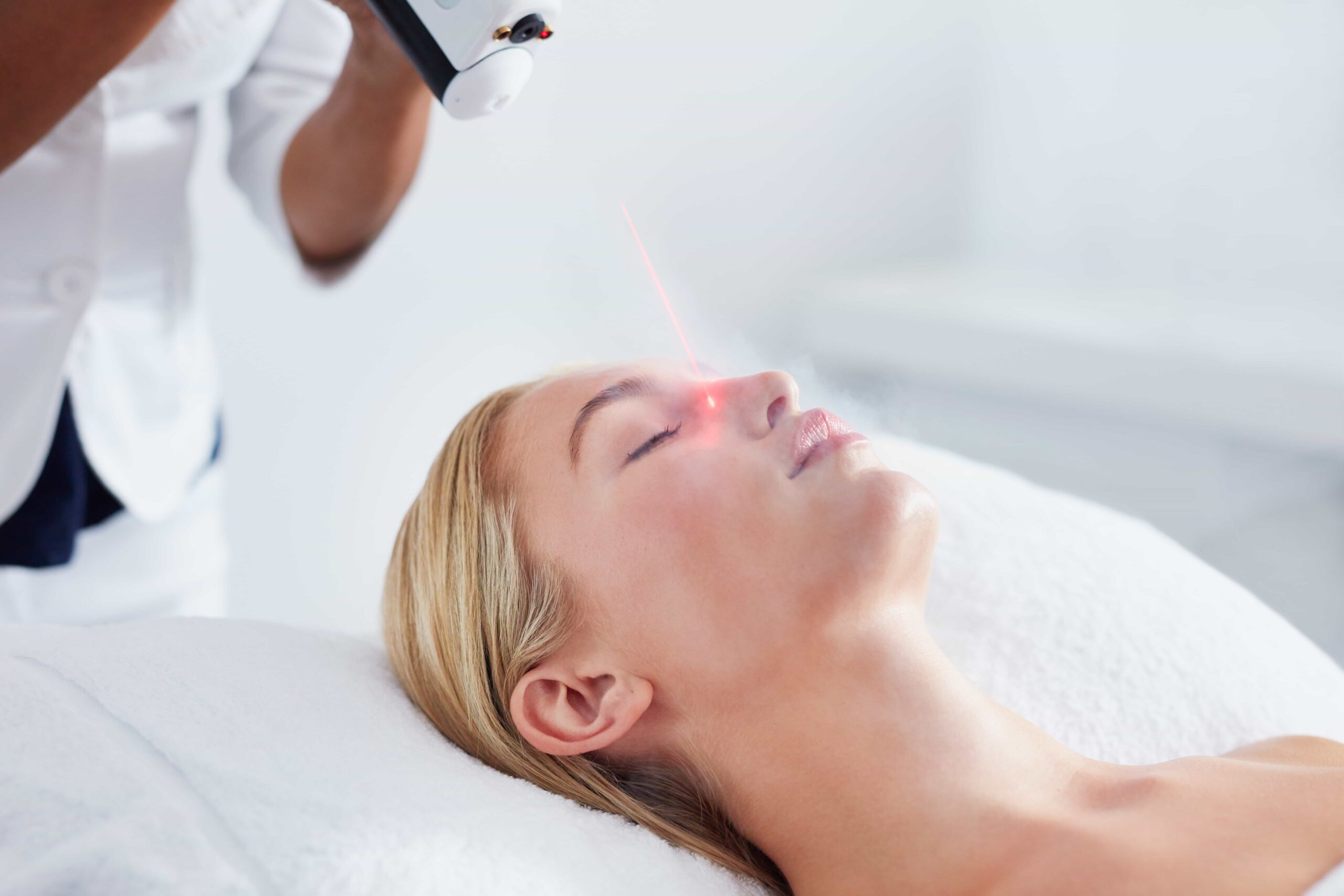 Group of aesthetic medical professionals posing confidently in a modern clinical setting.