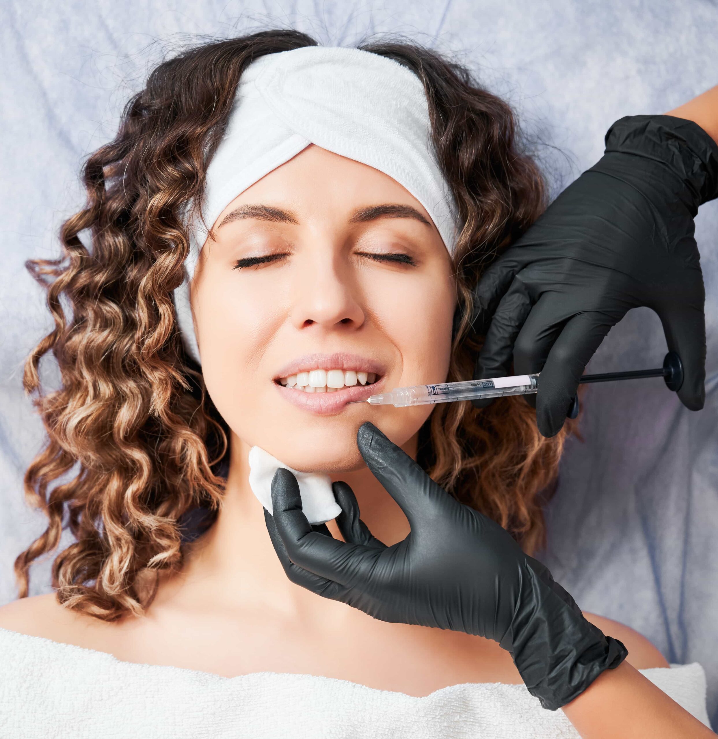 Woman laying flat on medical bed receiving injection  From Trained Practitioner 