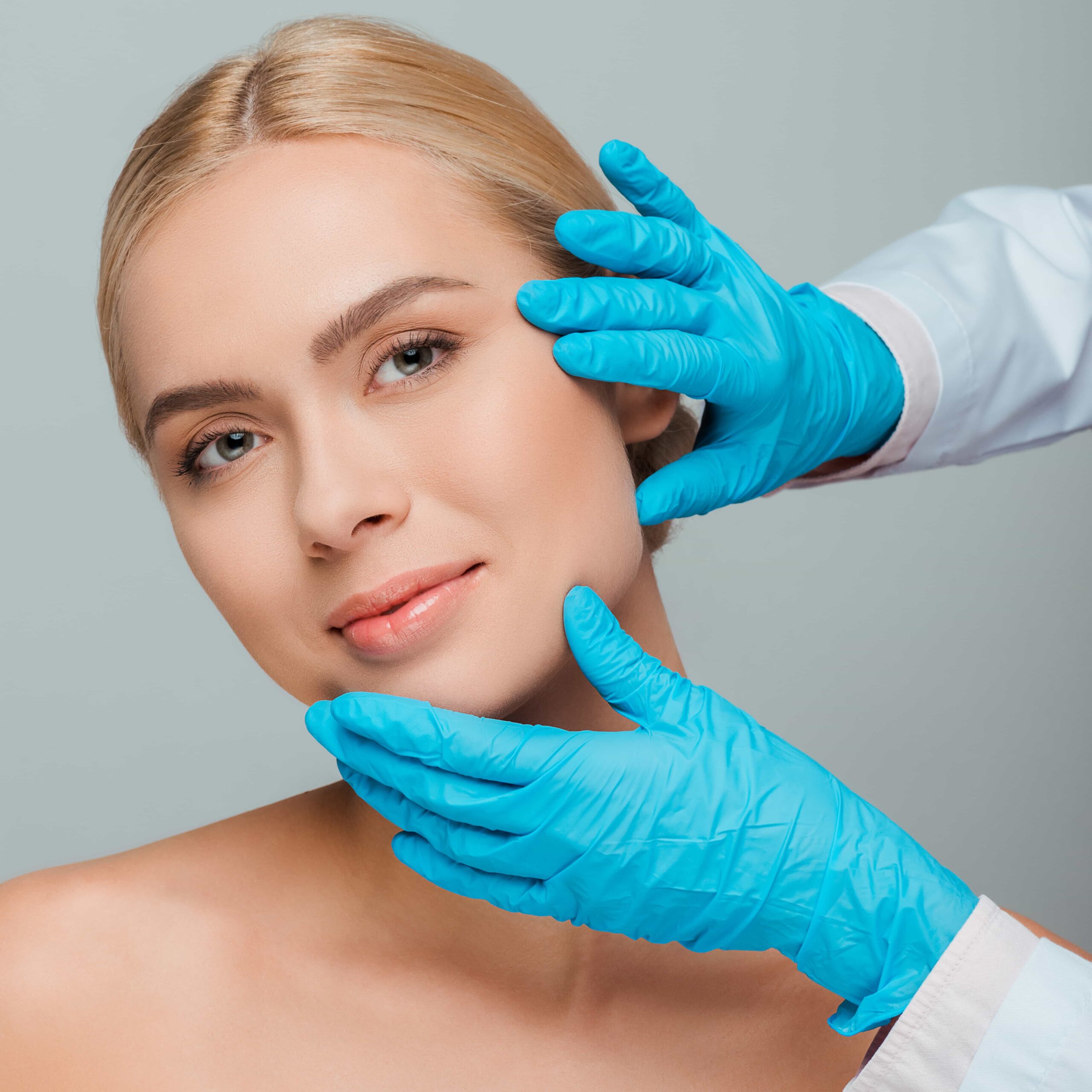 Focused Caucasian professional female dermatologist conducting a young woman skin assessment before a cosmetic treatment