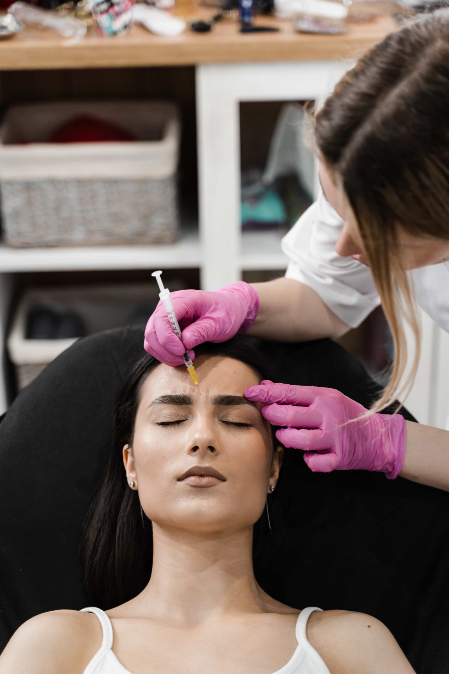 Woman receiving Botox injections to forehead area. 