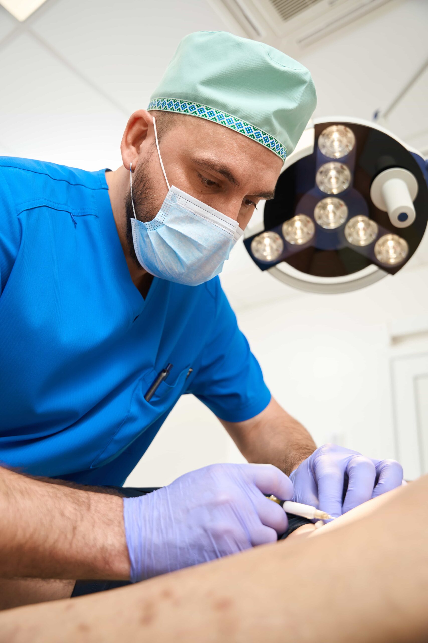 Doctor adding injections to leg area on patient. 